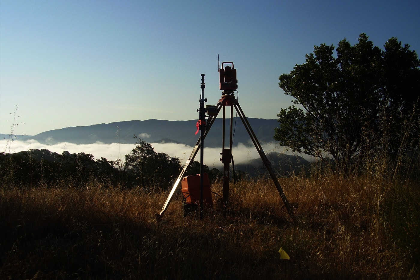 Surveying instrument in mountain landscape