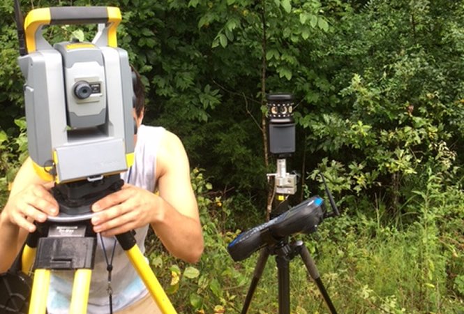 Land surveyor operating total station